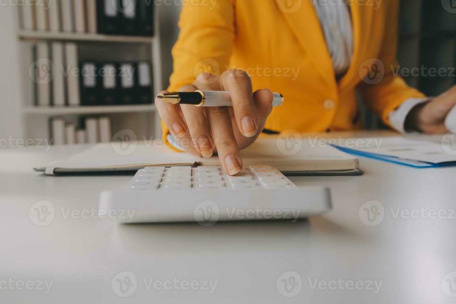 Close up woman work on project sit at desk use laptop and calculator, look at pc screen with diagrams, calculates bills, check financial documents, leads accounting of company, plan investment concept photo