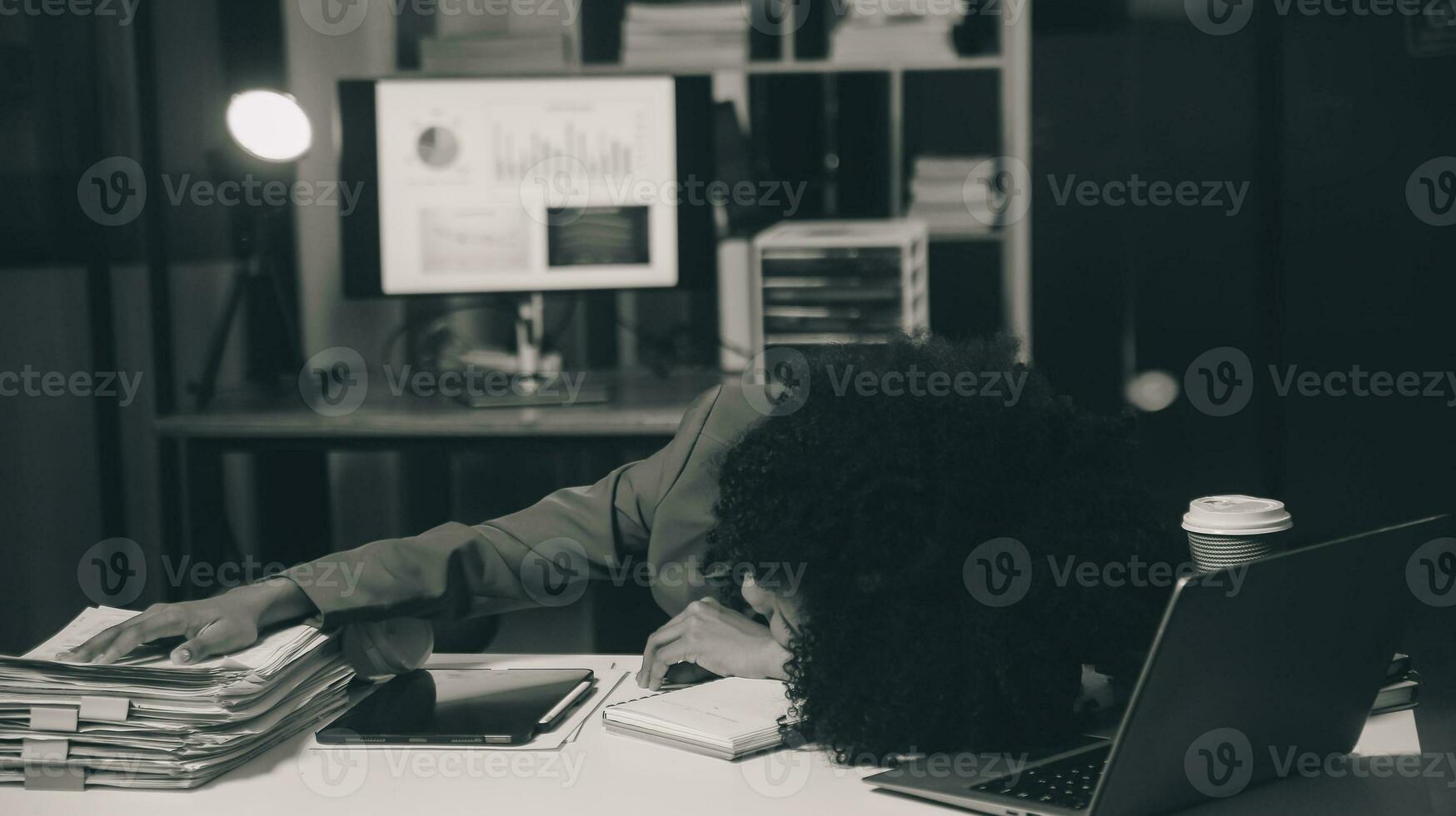 Asian woman overwork and sleep on the table after she feeling very try.Depression and anxiety.Chinese office girl sleeping after can not find data and solution to do her report.Workaholic people. photo