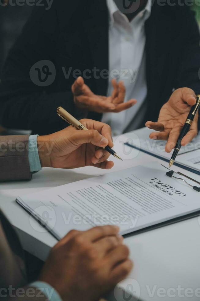 Business and lawyers discussing contract papers with brass scale on desk in office. Law, legal services, advice, justice and law concept picture with film grain effect photo