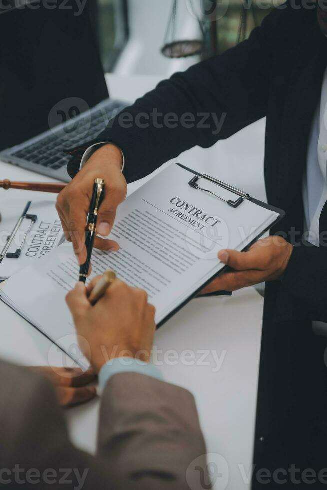 Business and lawyers discussing contract papers with brass scale on desk in office. Law, legal services, advice, justice and law concept picture with film grain effect photo