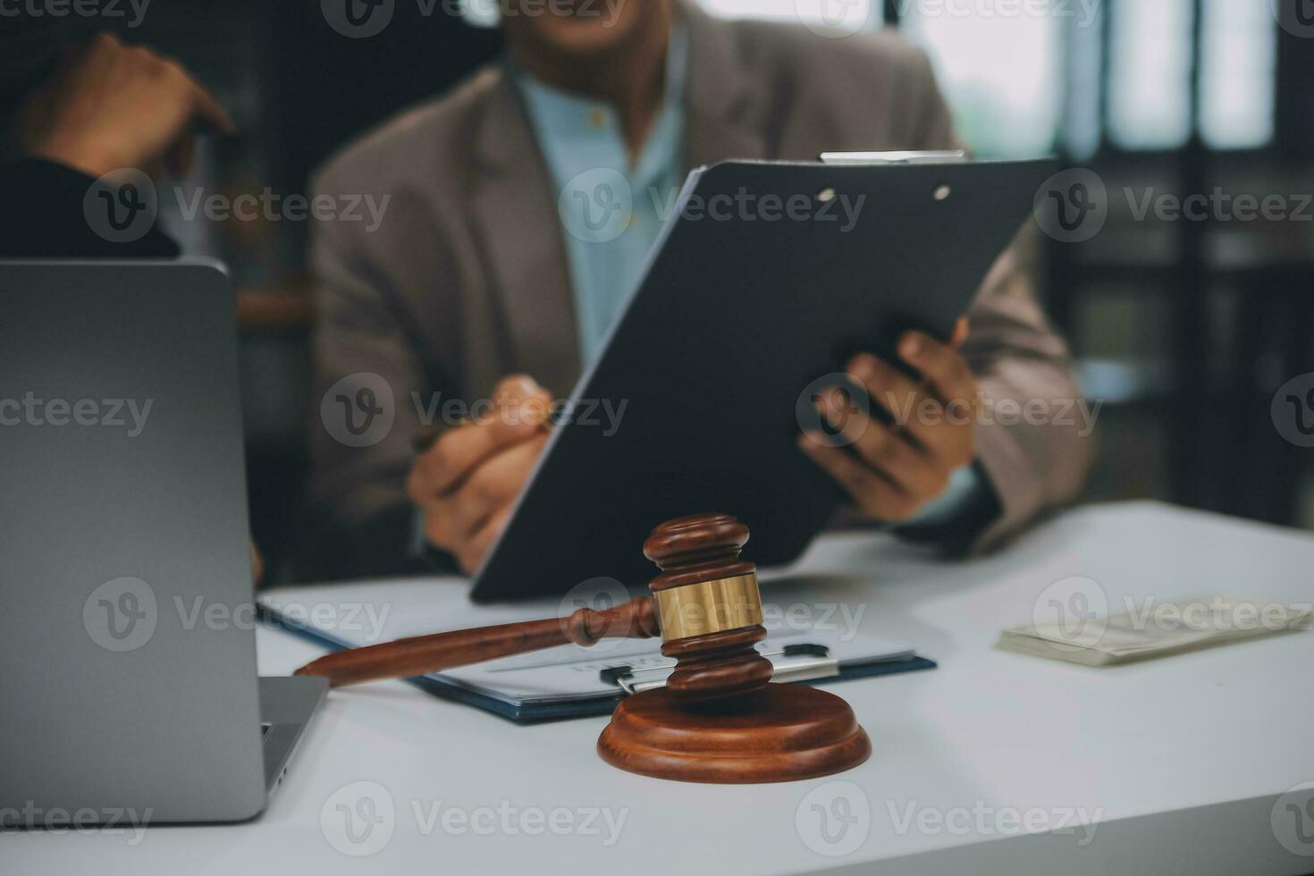 Business and lawyers discussing contract papers with brass scale on desk in office. Law, legal services, advice, justice and law concept picture with film grain effect photo