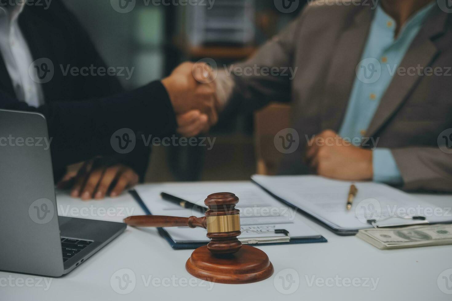 Business and lawyers discussing contract papers with brass scale on desk in office. Law, legal services, advice, justice and law concept picture with film grain effect photo