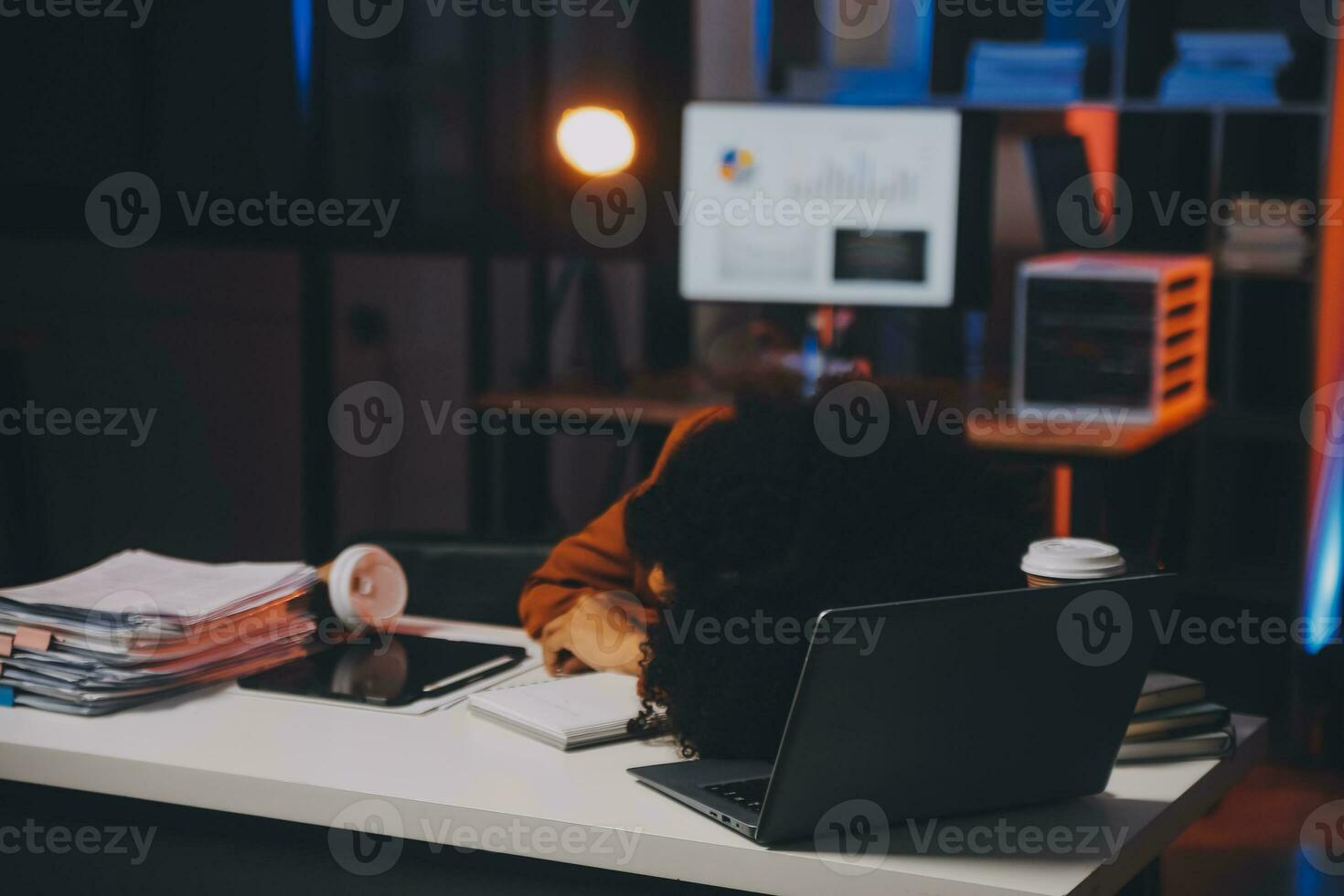 Asian woman overwork and sleep on the table after she feeling very try.Depression and anxiety.Chinese office girl sleeping after can not find data and solution to do her report.Workaholic people. photo