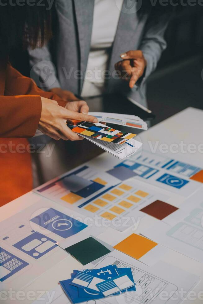 team of UI UX web designer are working together to develop mobile responsive websites. Mobile Mockup photo