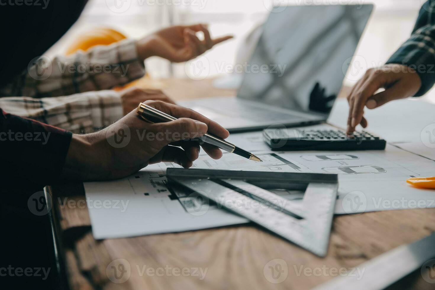 Construction and structure concept of engineer working drawing on blueprint meeting for project working with partner on model building and engineering tools in working site, construction concept. photo