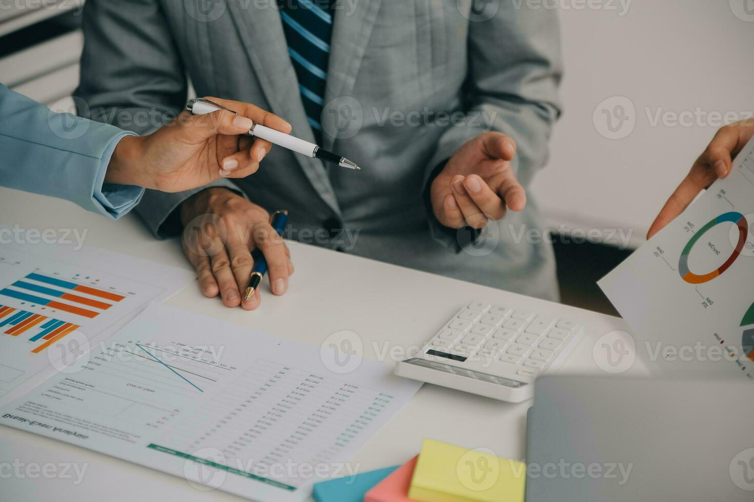 Financial analysts analyze business financial reports on a digital tablet planning investment project during a discussion at a meeting of corporate showing the results of their successful teamwork. photo