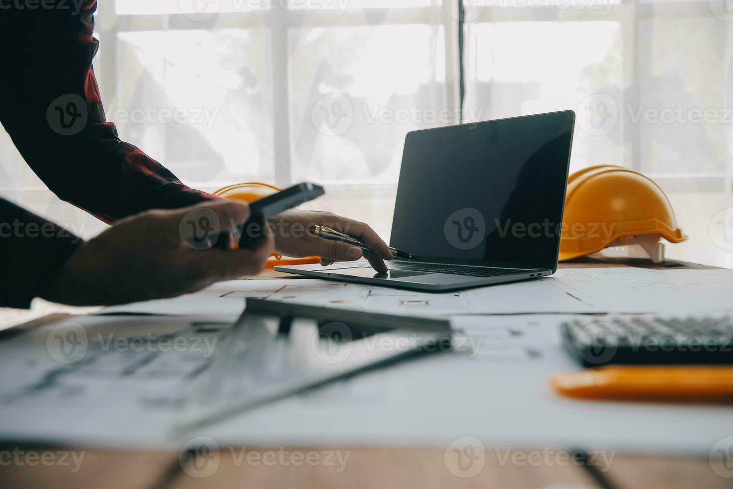 Construction and structure concept of engineer working drawing on blueprint meeting for project working with partner on model building and engineering tools in working site, construction concept. photo