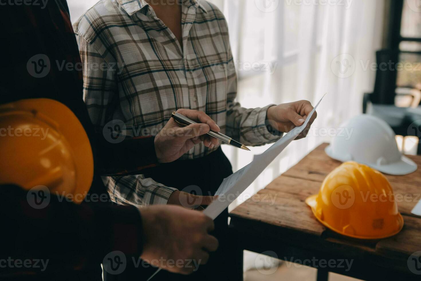 Construction and structure concept of engineer working drawing on blueprint meeting for project working with partner on model building and engineering tools in working site, construction concept. photo