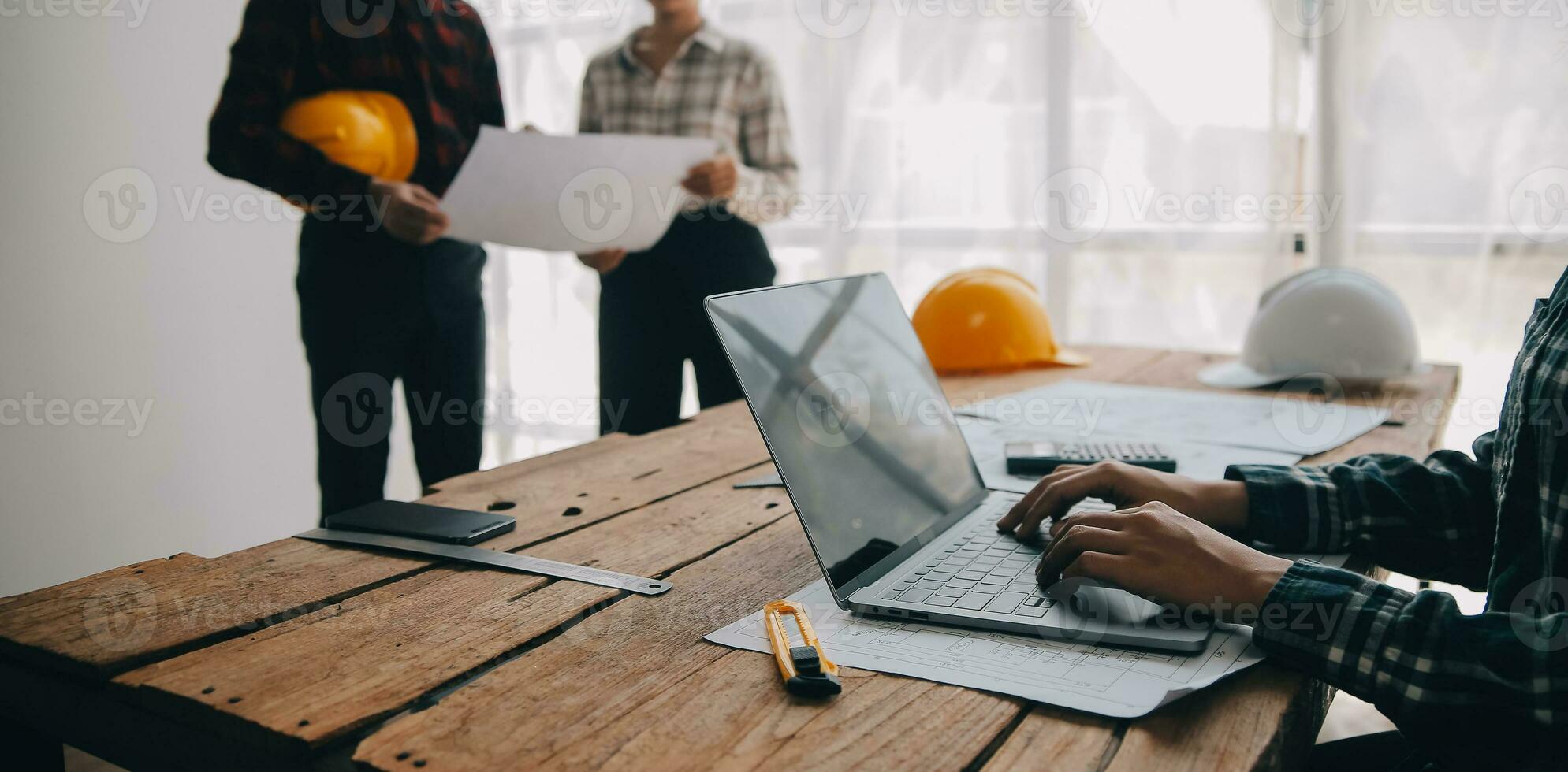Construction and structure concept of engineer working drawing on blueprint meeting for project working with partner on model building and engineering tools in working site, construction concept. photo