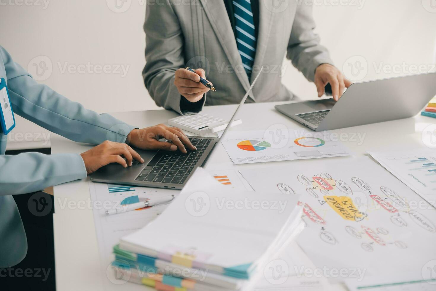 Financial analysts analyze business financial reports on a digital tablet planning investment project during a discussion at a meeting of corporate showing the results of their successful teamwork. photo