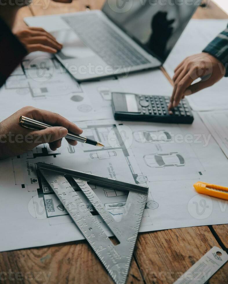 Construction and structure concept of engineer working drawing on blueprint meeting for project working with partner on model building and engineering tools in working site, construction concept. photo