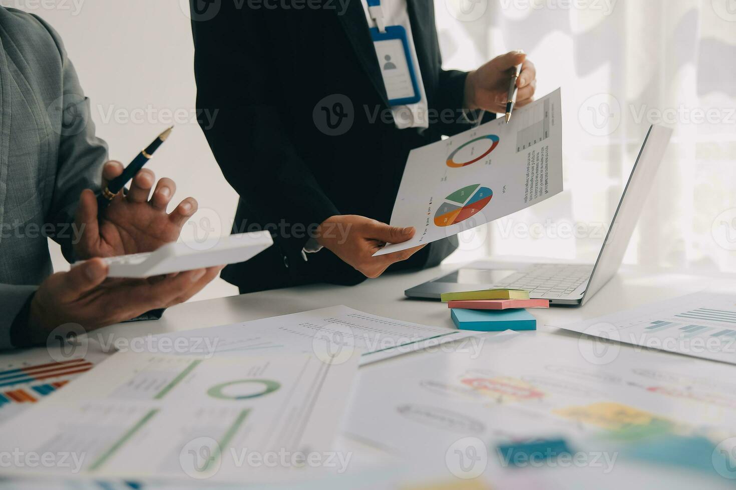 Financial analysts analyze business financial reports on a digital tablet planning investment project during a discussion at a meeting of corporate showing the results of their successful teamwork. photo