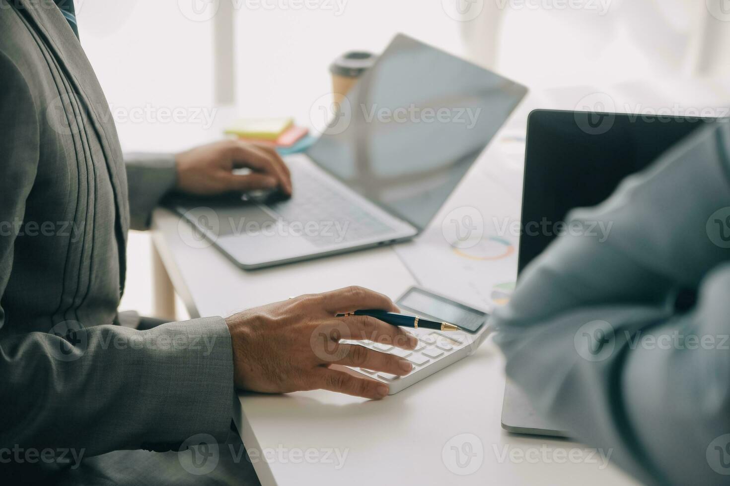 Financial analysts analyze business financial reports on a digital tablet planning investment project during a discussion at a meeting of corporate showing the results of their successful teamwork. photo