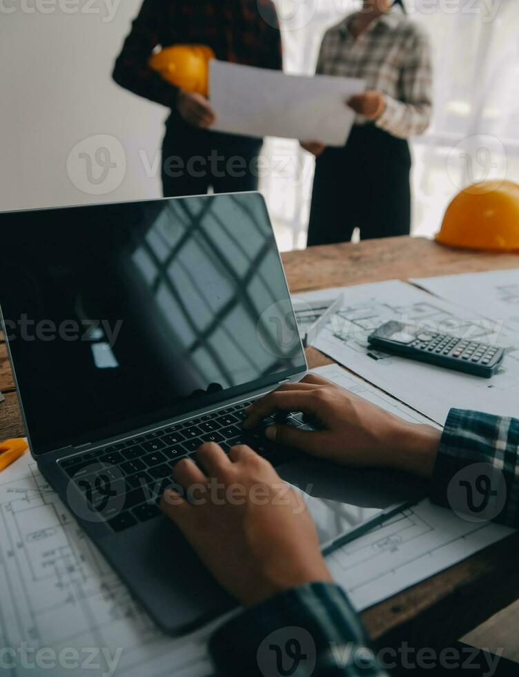 Construction and structure concept of engineer working drawing on blueprint meeting for project working with partner on model building and engineering tools in working site, construction concept. photo
