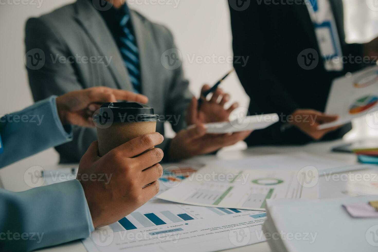 Financial analysts analyze business financial reports on a digital tablet planning investment project during a discussion at a meeting of corporate showing the results of their successful teamwork. photo