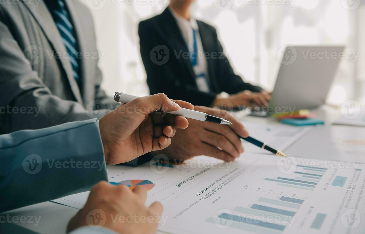Financial analysts analyze business financial reports on a digital tablet planning investment project during a discussion at a meeting of corporate showing the results of their successful teamwork. photo