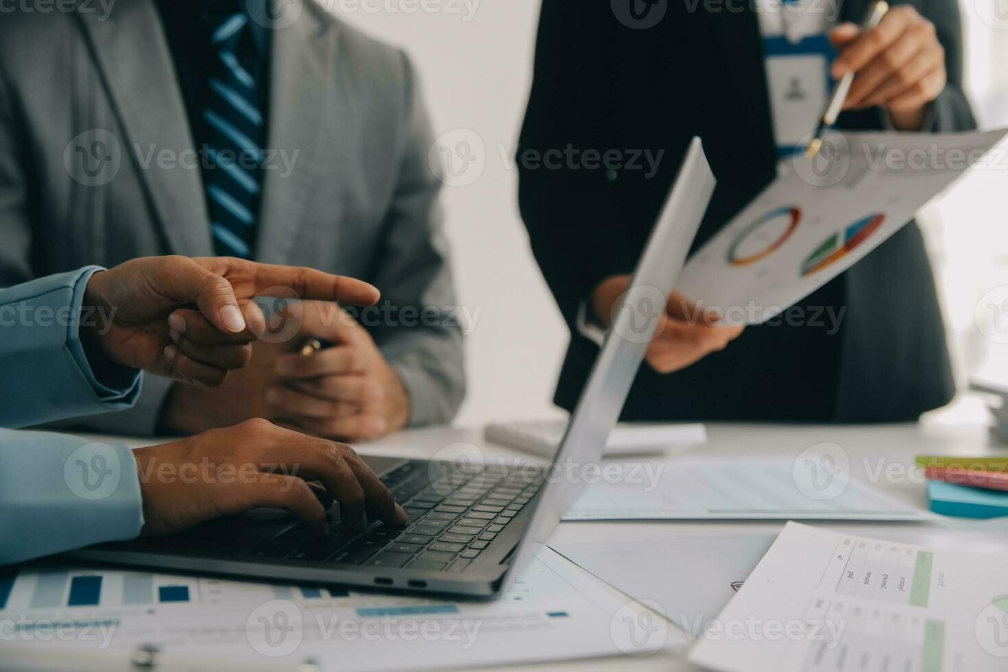 Financial analysts analyze business financial reports on a digital tablet planning investment project during a discussion at a meeting of corporate showing the results of their successful teamwork. photo