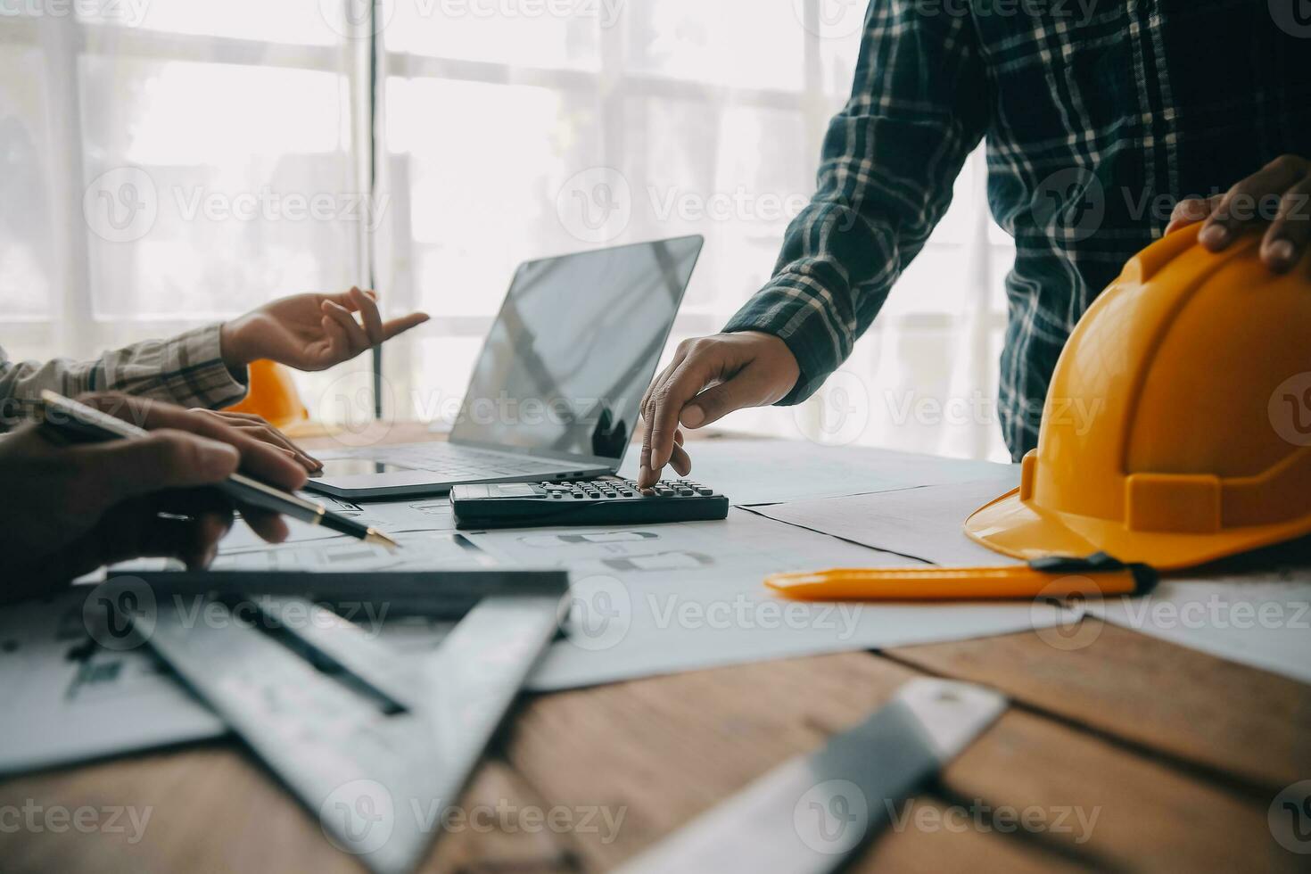 Construction and structure concept of engineer working drawing on blueprint meeting for project working with partner on model building and engineering tools in working site, construction concept. photo