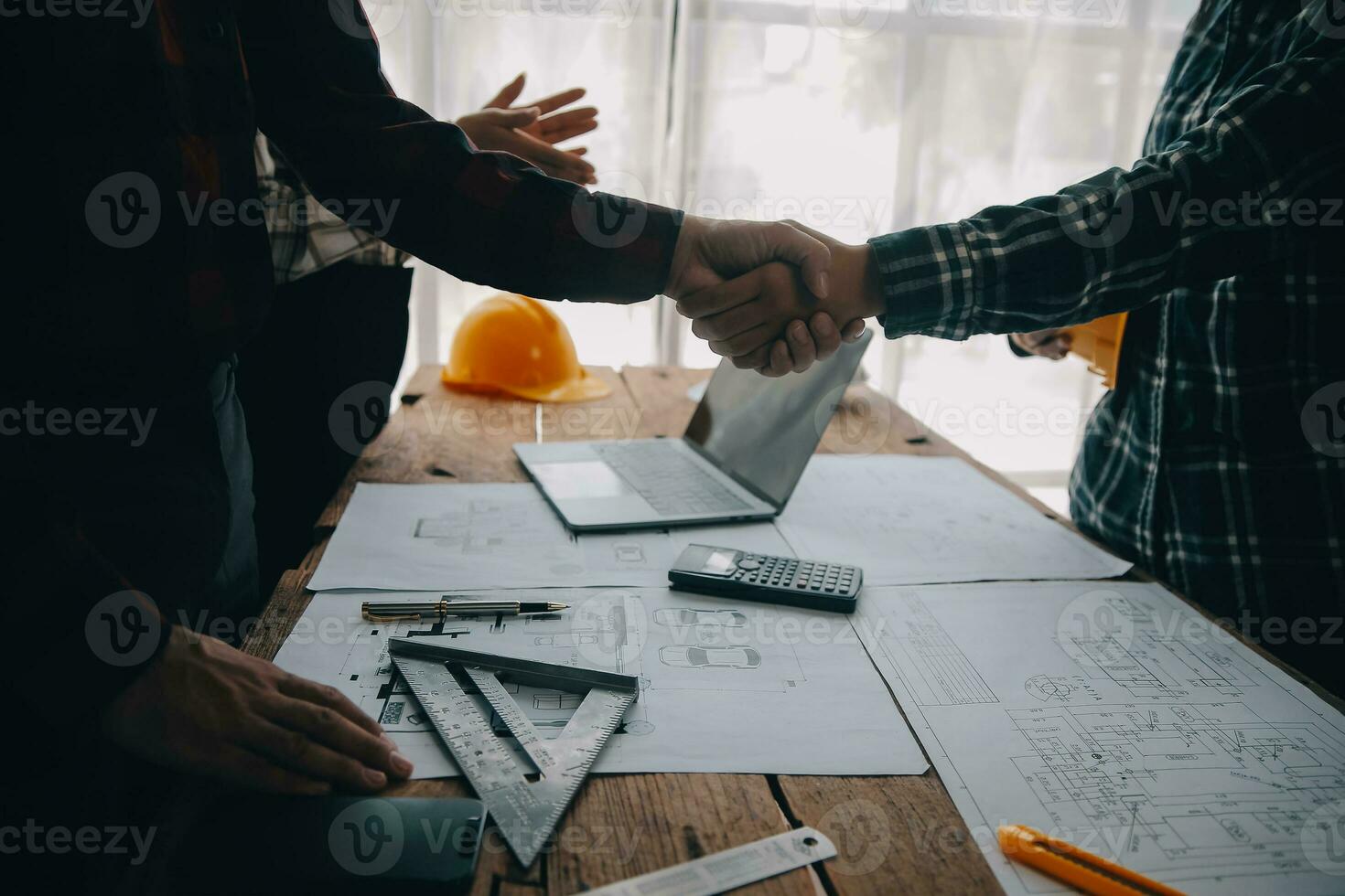 Construction and structure concept of engineer working drawing on blueprint meeting for project working with partner on model building and engineering tools in working site, construction concept. photo