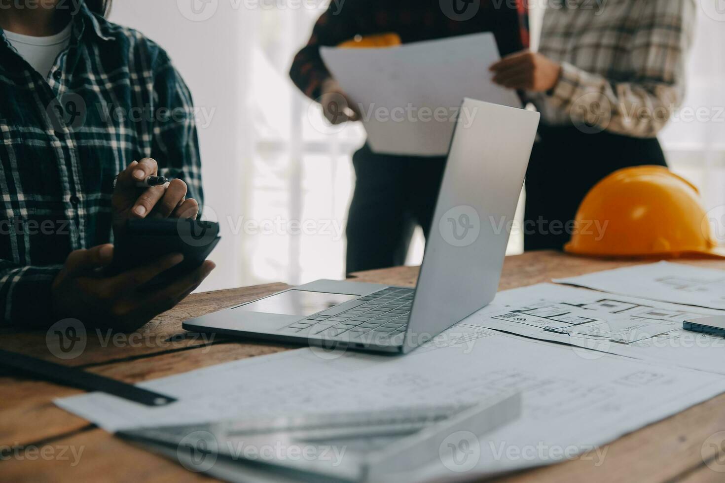 Construction and structure concept of engineer working drawing on blueprint meeting for project working with partner on model building and engineering tools in working site, construction concept. photo