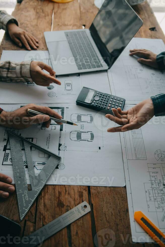 Construction and structure concept of engineer working drawing on blueprint meeting for project working with partner on model building and engineering tools in working site, construction concept. photo