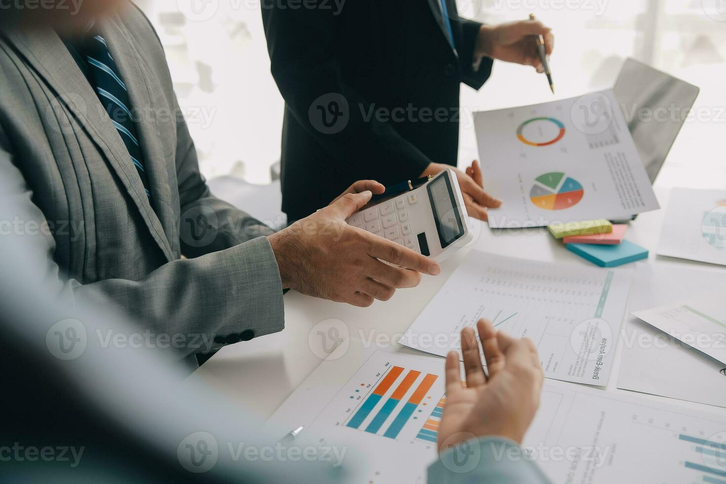 Financial analysts analyze business financial reports on a digital tablet planning investment project during a discussion at a meeting of corporate showing the results of their successful teamwork. photo