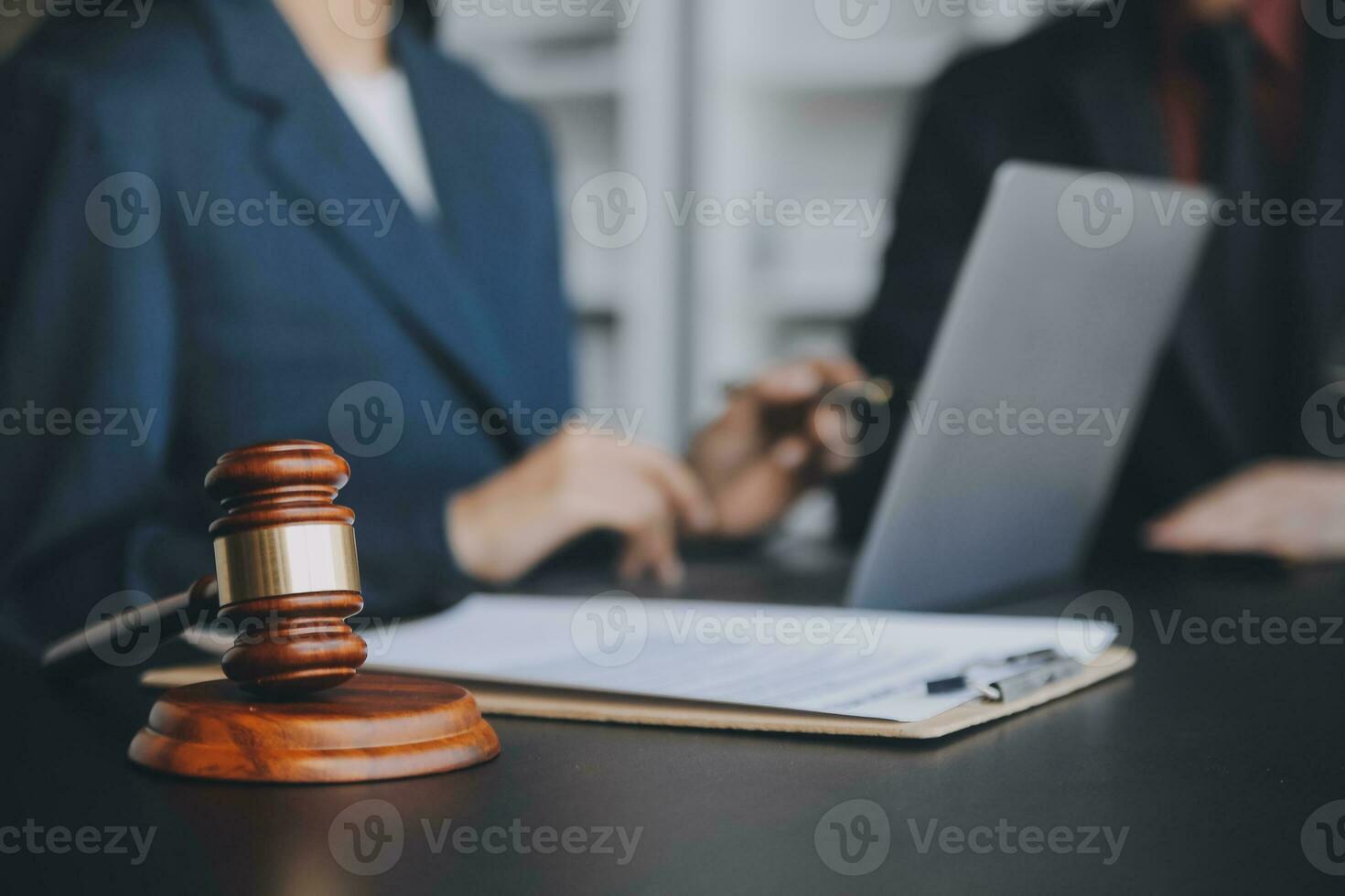 Business and lawyers discussing contract papers with brass scale on desk in office. Law, legal services, advice, justice and law concept picture with film grain effect photo