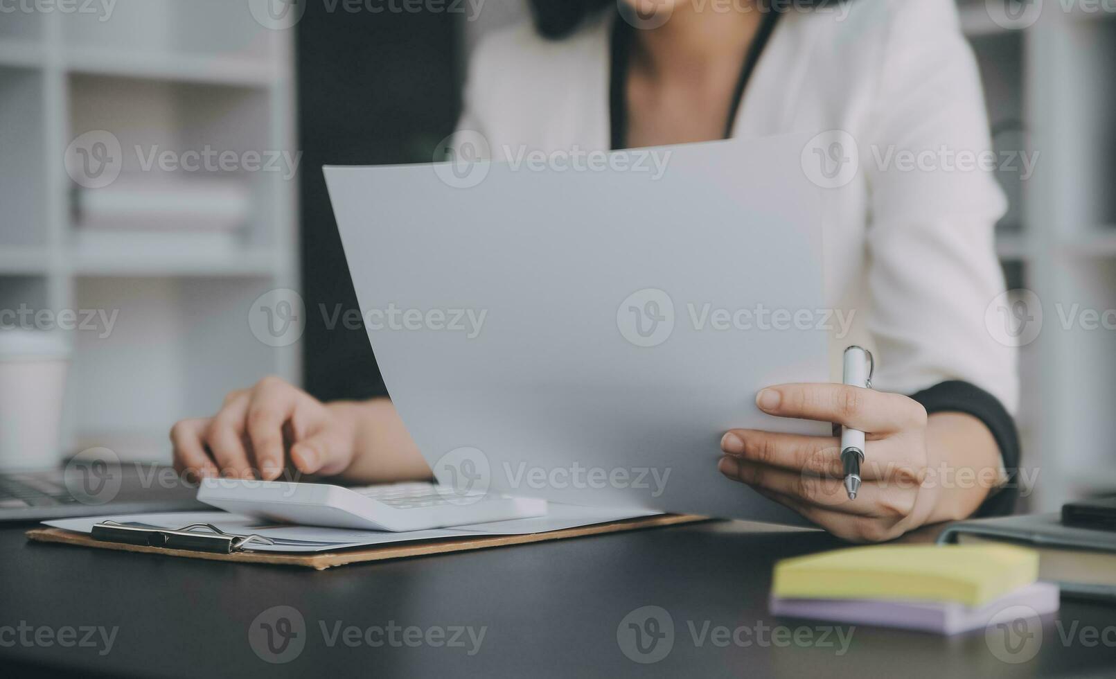 Audit concept,Administrator business man financial inspector and secretary making report calculating balance. Internal Revenue Service checking document. photo