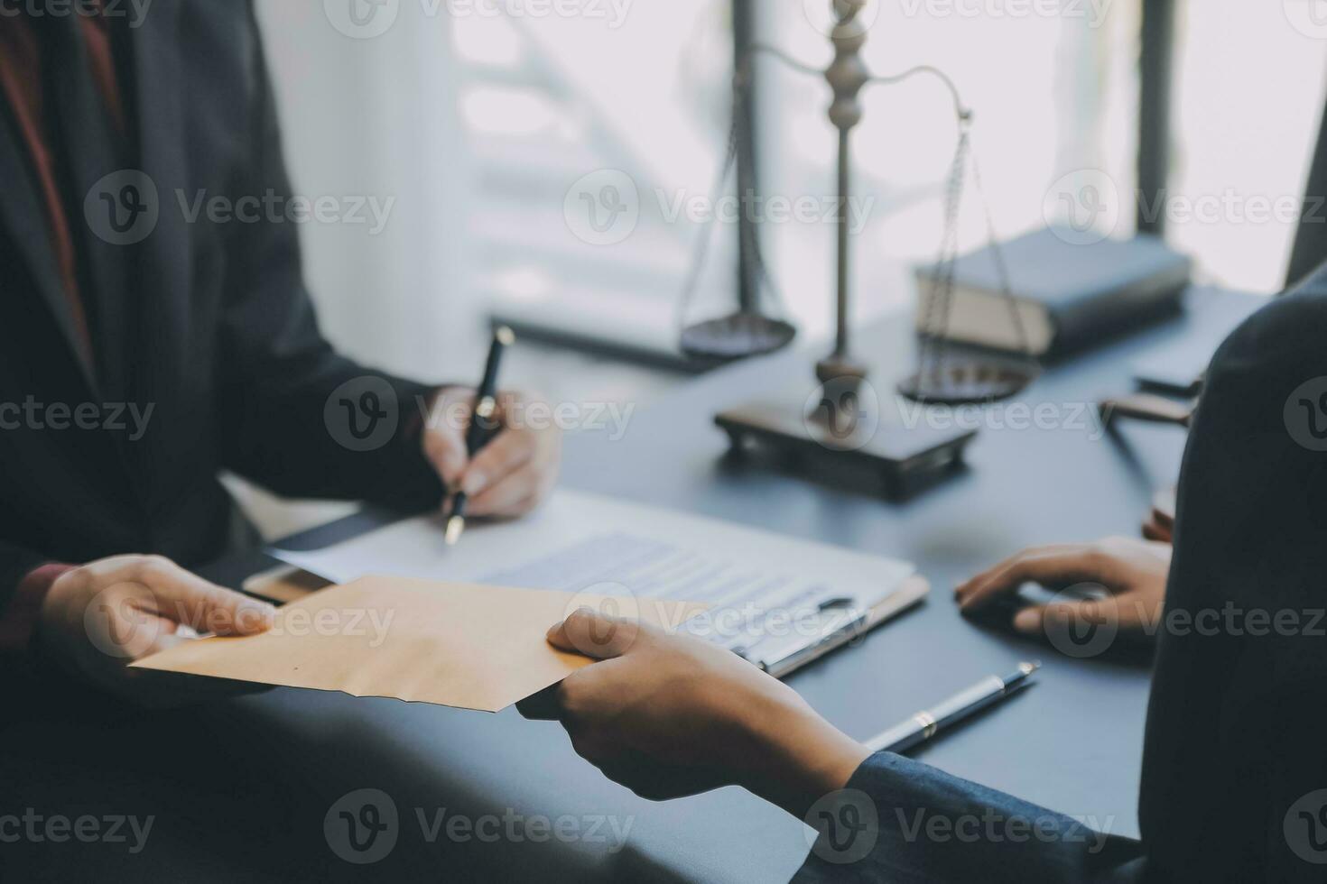 Business and lawyers discussing contract papers with brass scale on desk in office. Law, legal services, advice, justice and law concept picture with film grain effect photo