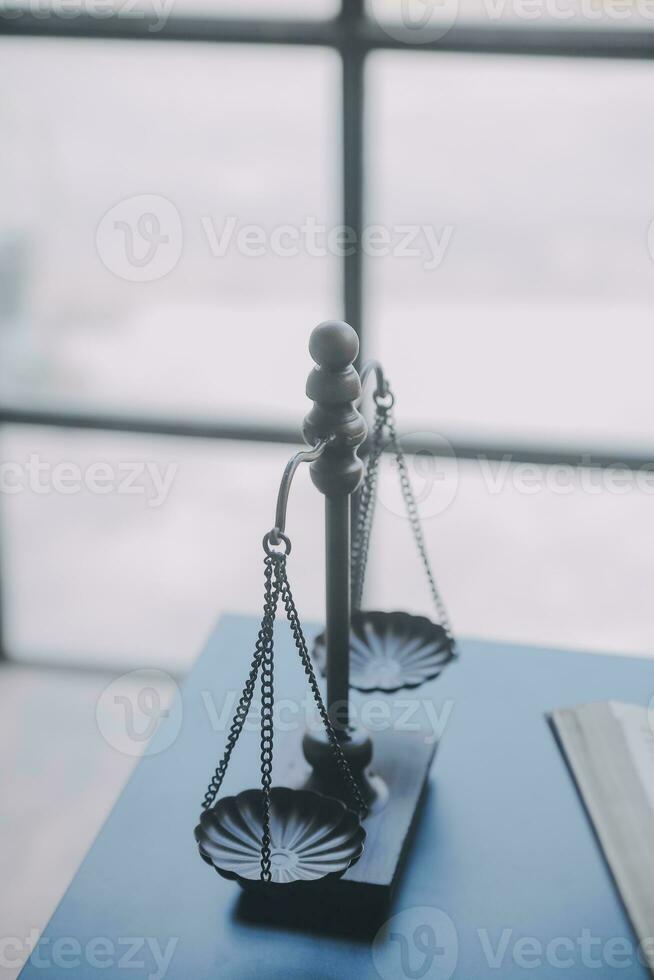 Business and lawyers discussing contract papers with brass scale on desk in office. Law, legal services, advice, justice and law concept picture with film grain effect photo