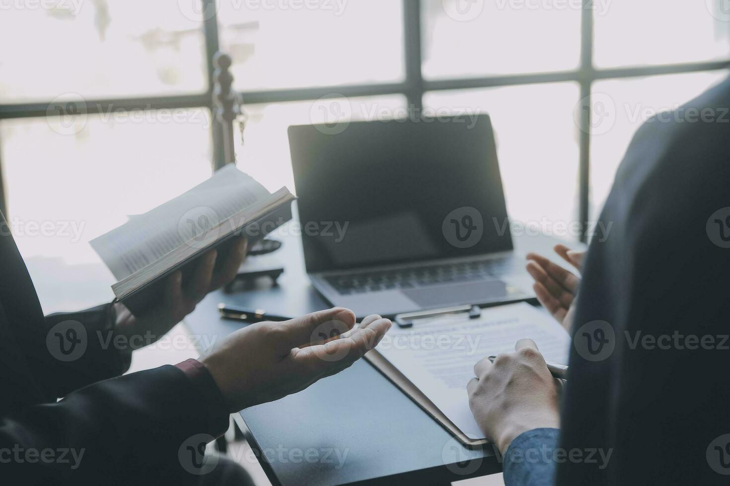 Business and lawyers discussing contract papers with brass scale on desk in office. Law, legal services, advice, justice and law concept picture with film grain effect photo
