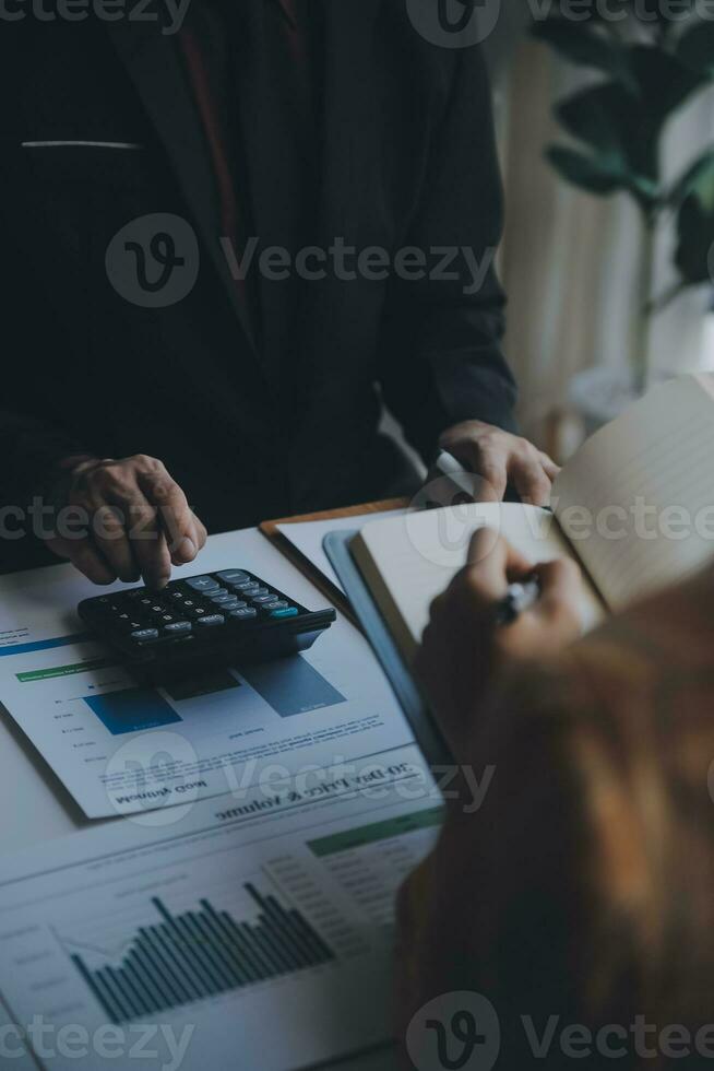 Audit concept,Administrator business man financial inspector and secretary making report calculating balance. Internal Revenue Service checking document. photo