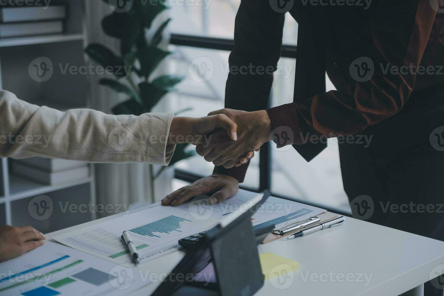 Financial analysts analyze business financial reports on a digital tablet planning investment project during a discussion at a meeting of corporate showing the results of their successful teamwork. photo