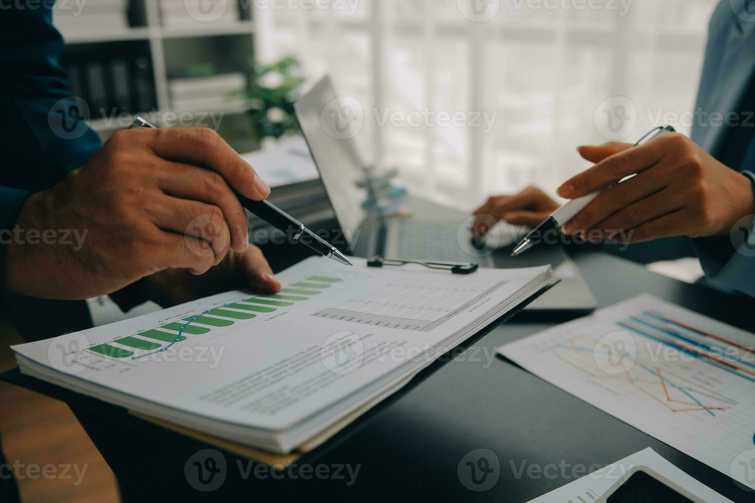 Financial Business team present. Business man hands hold documents with financial statistic stock photo, discussion, and analysis report data the charts and graphs. Finance Financial concept photo