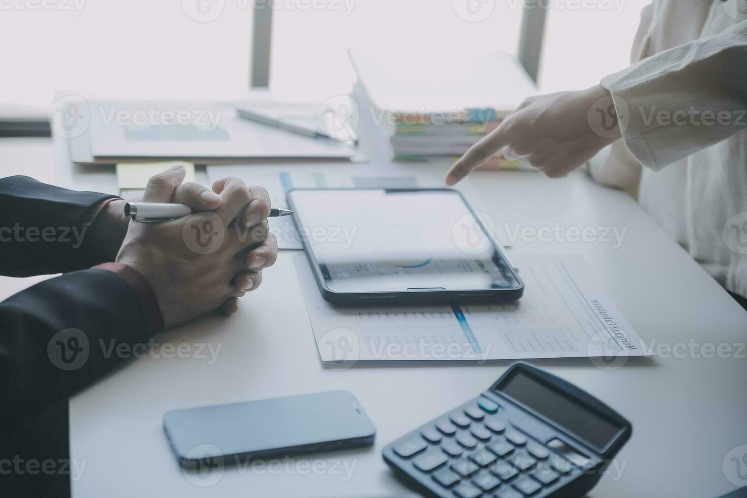 Financial analysts analyze business financial reports on a digital tablet planning investment project during a discussion at a meeting of corporate showing the results of their successful teamwork. photo