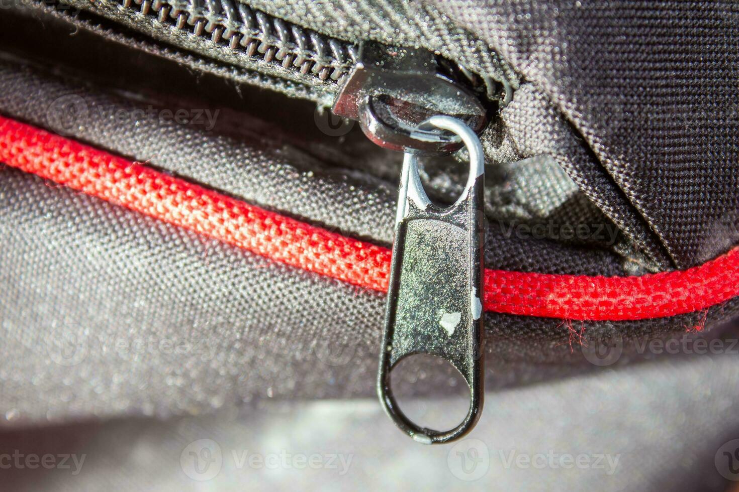 Metal zipper on a black bag, closeup photo