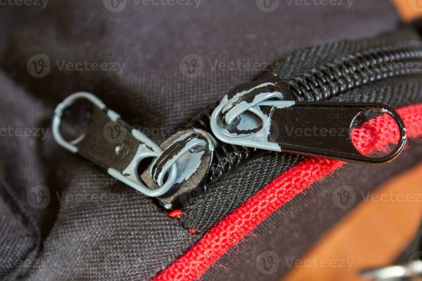 Metal zipper on a black bag, closeup photo