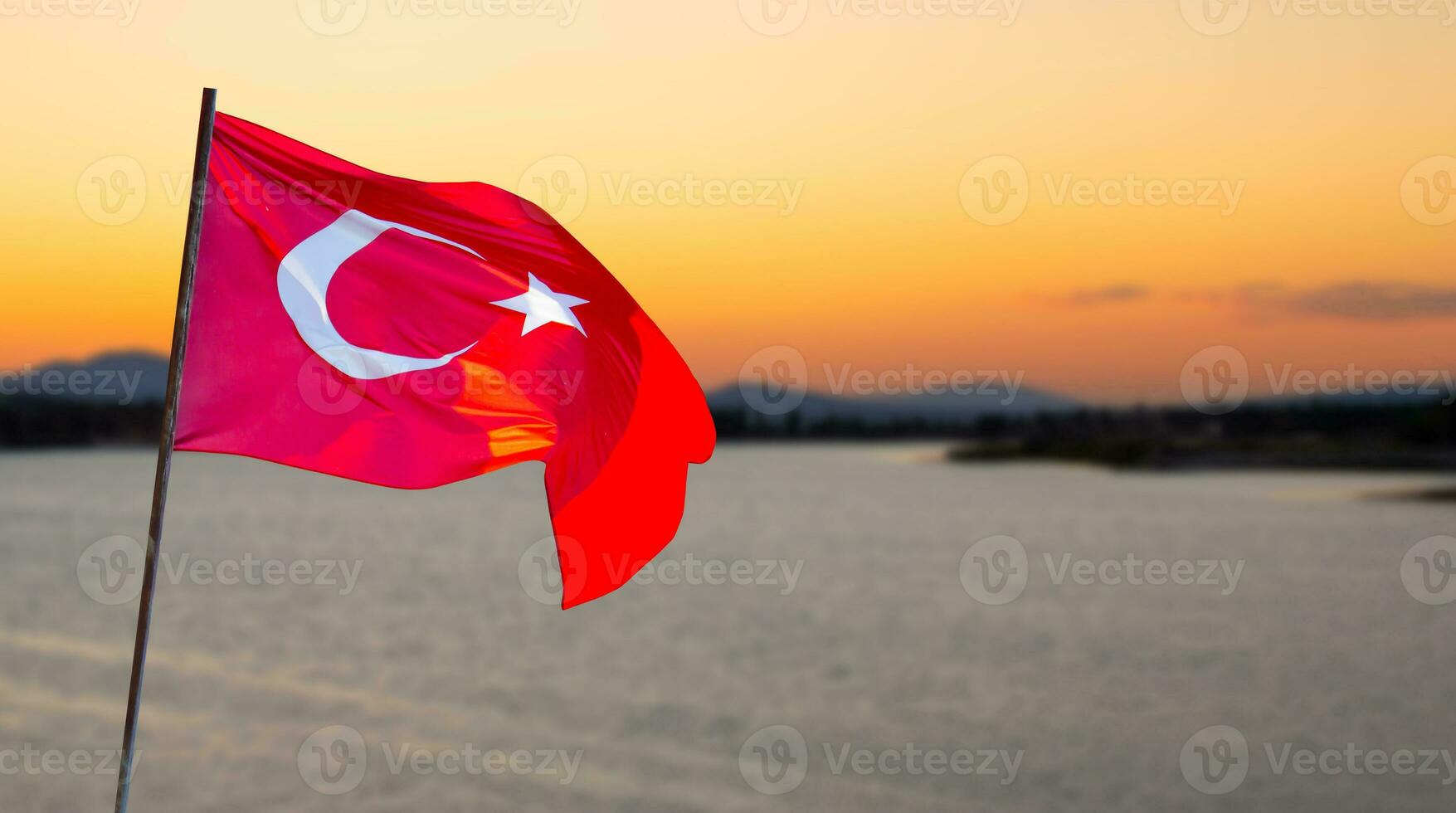 Turkish flag against lake view at the sunset. April 23, August 30, October 29 celebration photo. Copy space for text. Flag of Turkey. photo