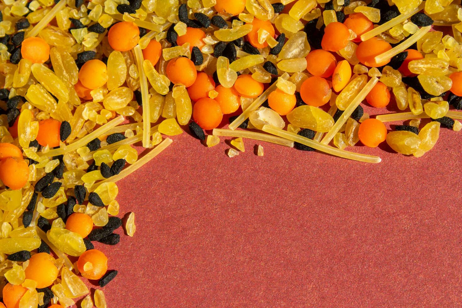 Various dried food on a red background. Top view of legumes. High protein foods. Flat lay. photo