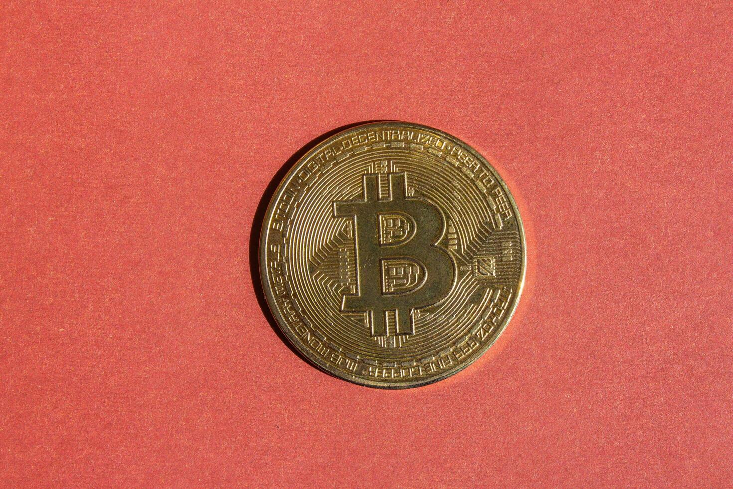 dorado bitcoin aislado en un rojo antecedentes. parte superior vista, plano poner. foto