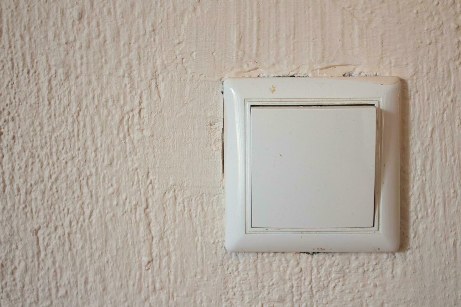 Light switch on concrete wall with copy space photo