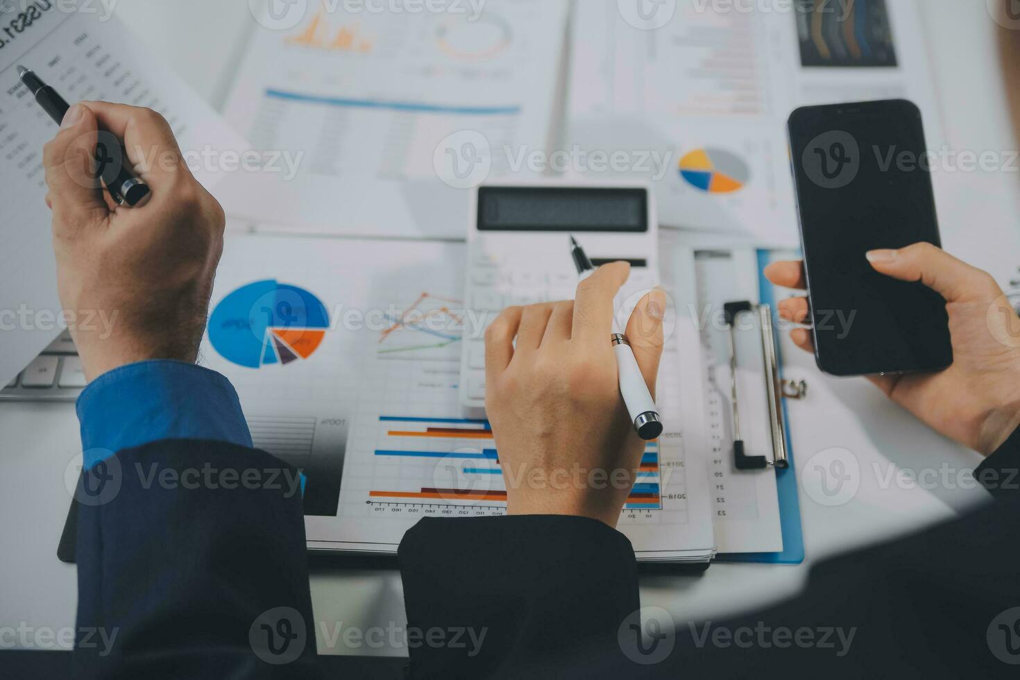 Financial analysts analyze business financial reports on a digital tablet planning investment project during a discussion at a meeting of corporate showing the results of their successful teamwork. photo