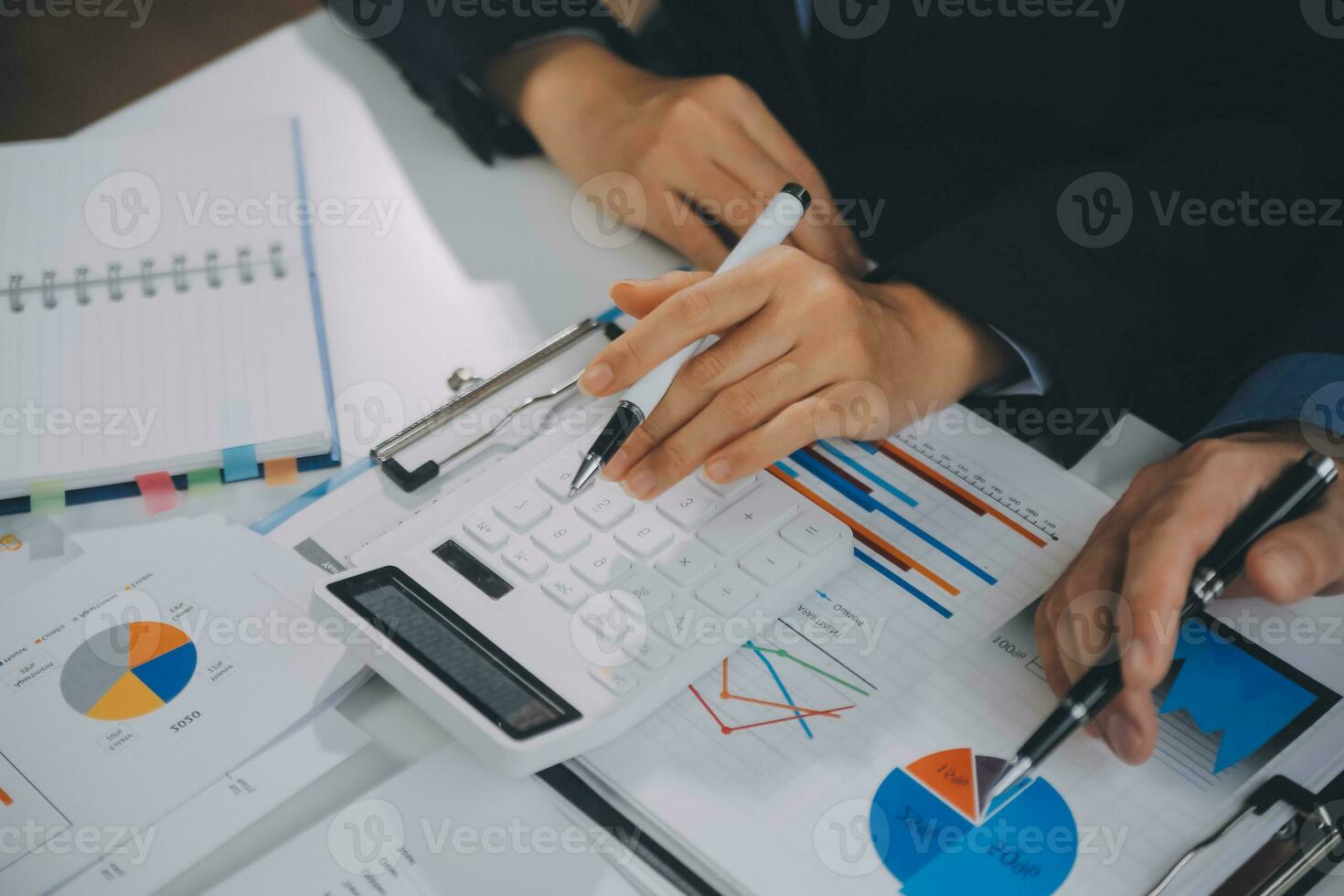 Financial analysts analyze business financial reports on a digital tablet planning investment project during a discussion at a meeting of corporate showing the results of their successful teamwork. photo