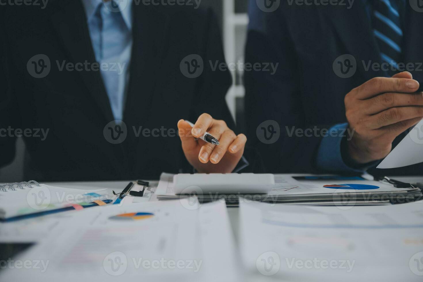 Financial analysts analyze business financial reports on a digital tablet planning investment project during a discussion at a meeting of corporate showing the results of their successful teamwork. photo