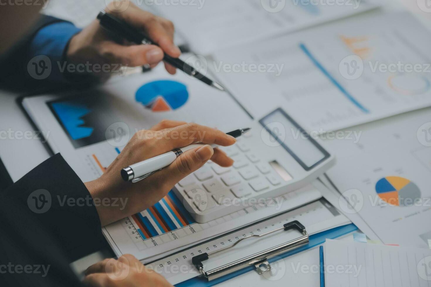 Financial analysts analyze business financial reports on a digital tablet planning investment project during a discussion at a meeting of corporate showing the results of their successful teamwork. photo