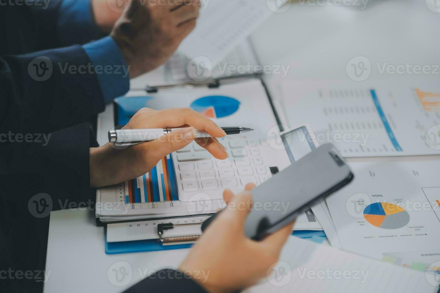 Financial analysts analyze business financial reports on a digital tablet planning investment project during a discussion at a meeting of corporate showing the results of their successful teamwork. photo