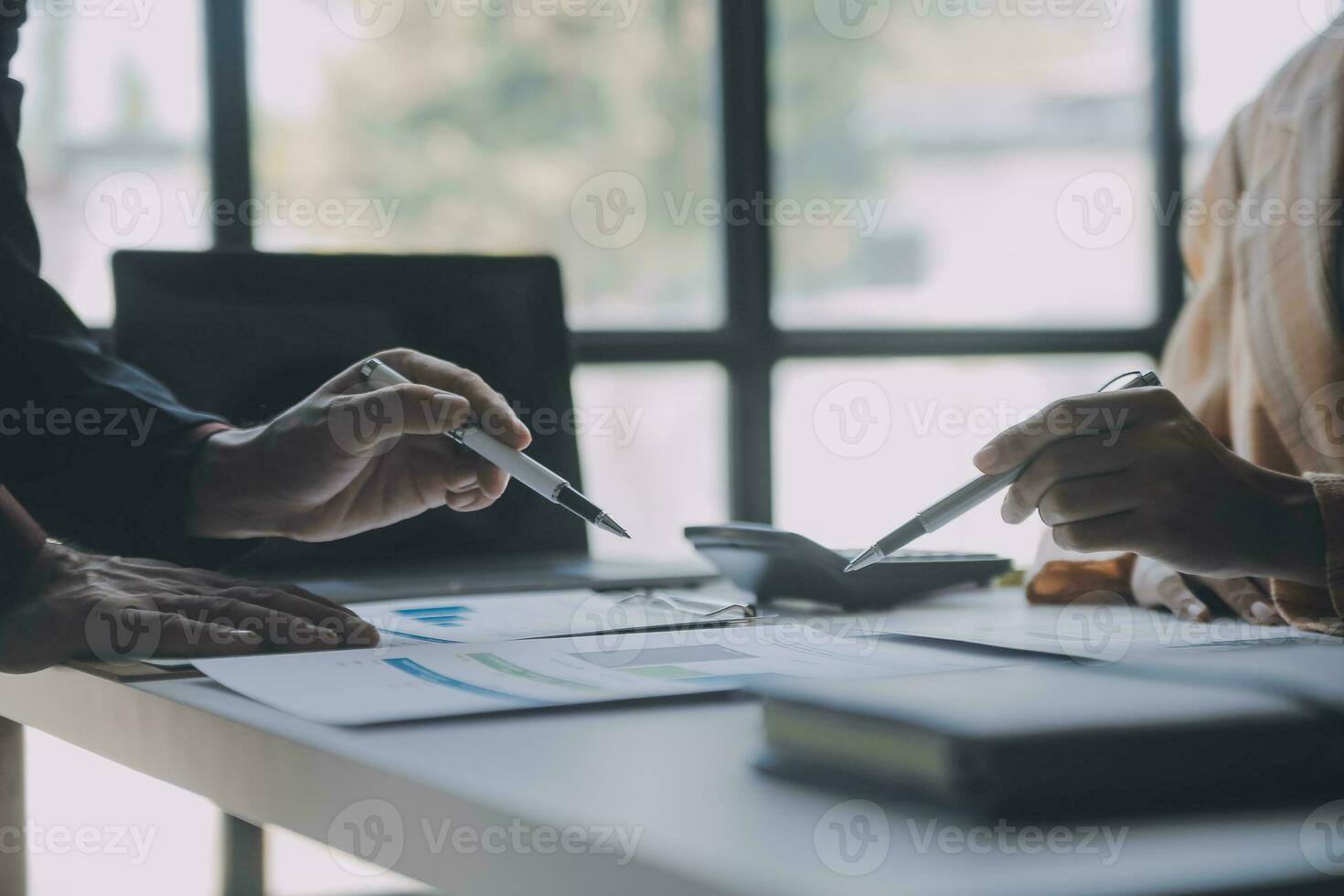 Financial analysts analyze business financial reports on a digital tablet planning investment project during a discussion at a meeting of corporate showing the results of their successful teamwork. photo