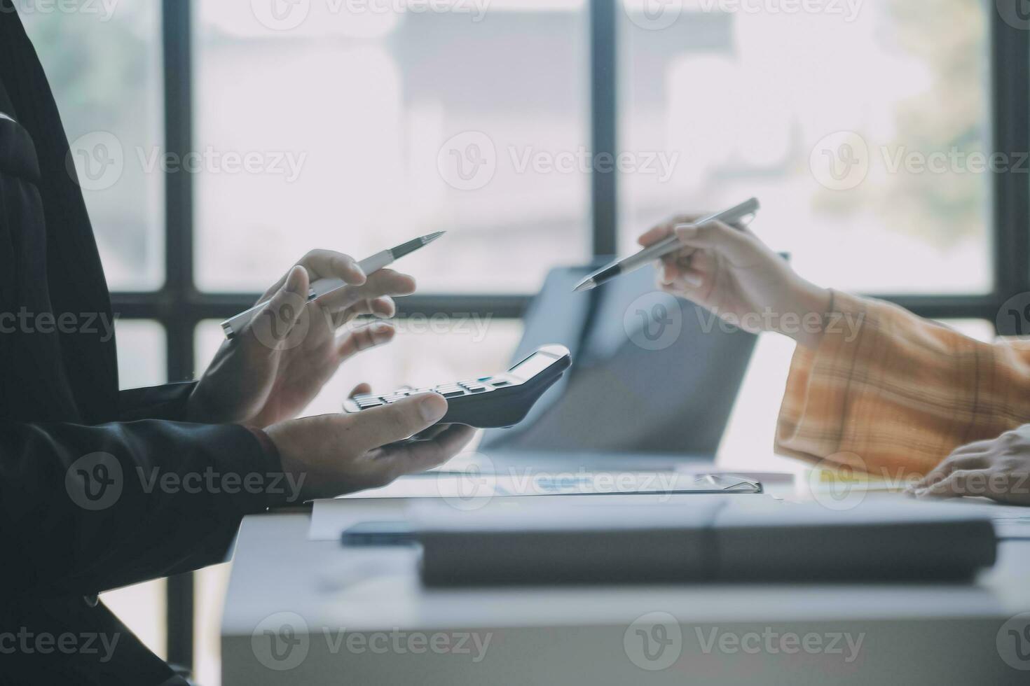 Financial analysts analyze business financial reports on a digital tablet planning investment project during a discussion at a meeting of corporate showing the results of their successful teamwork. photo
