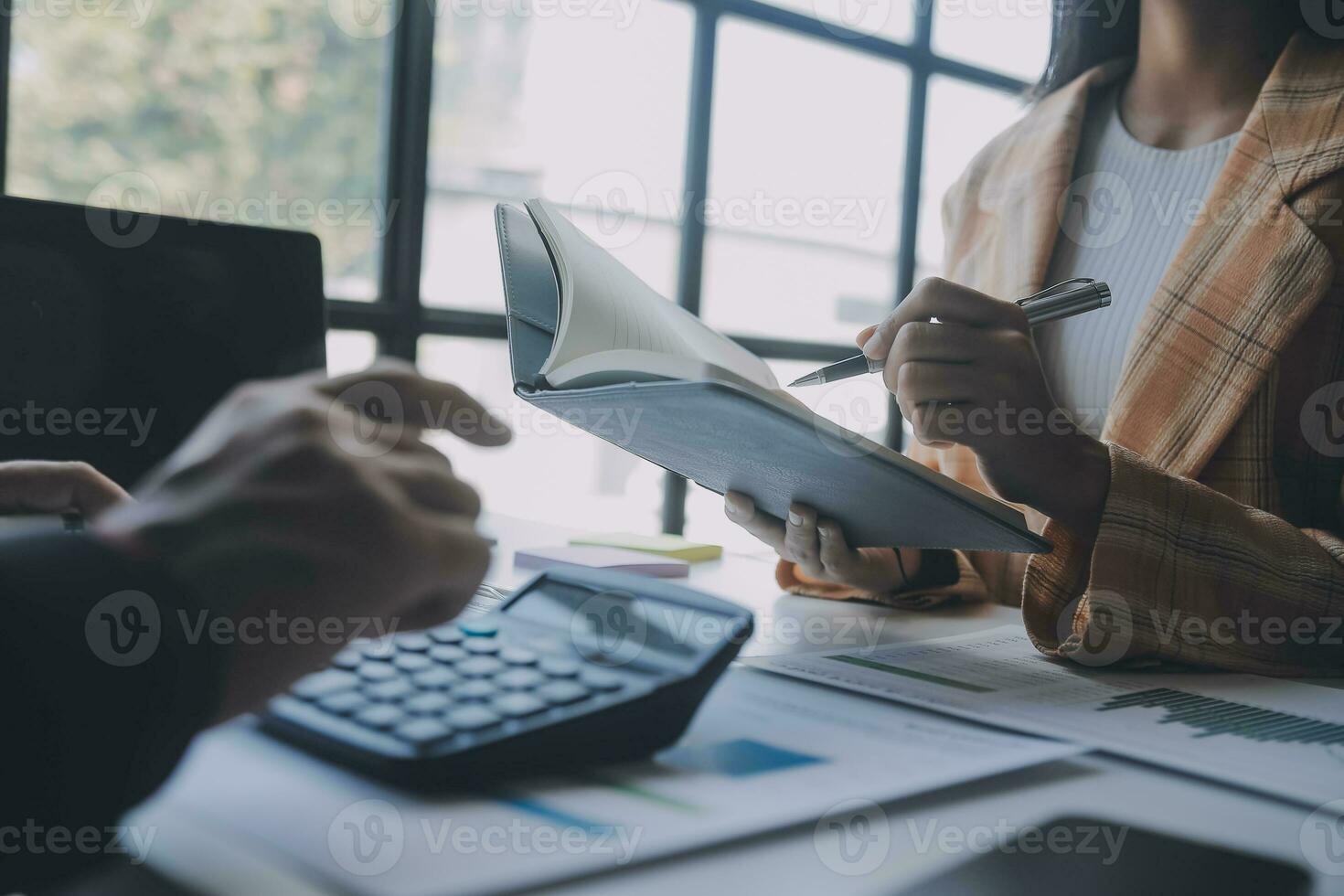 Financial analysts analyze business financial reports on a digital tablet planning investment project during a discussion at a meeting of corporate showing the results of their successful teamwork. photo
