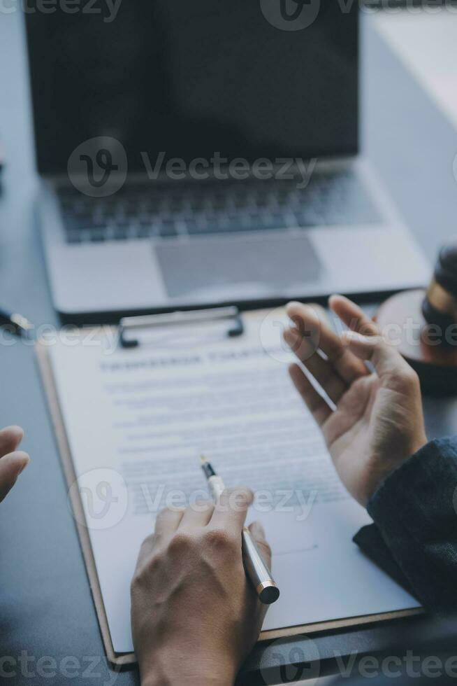 Business and lawyers discussing contract papers with brass scale on desk in office. Law, legal services, advice, justice and law concept picture with film grain effect photo